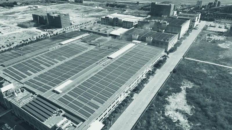 Aerial view of an industrial roof with solar panels